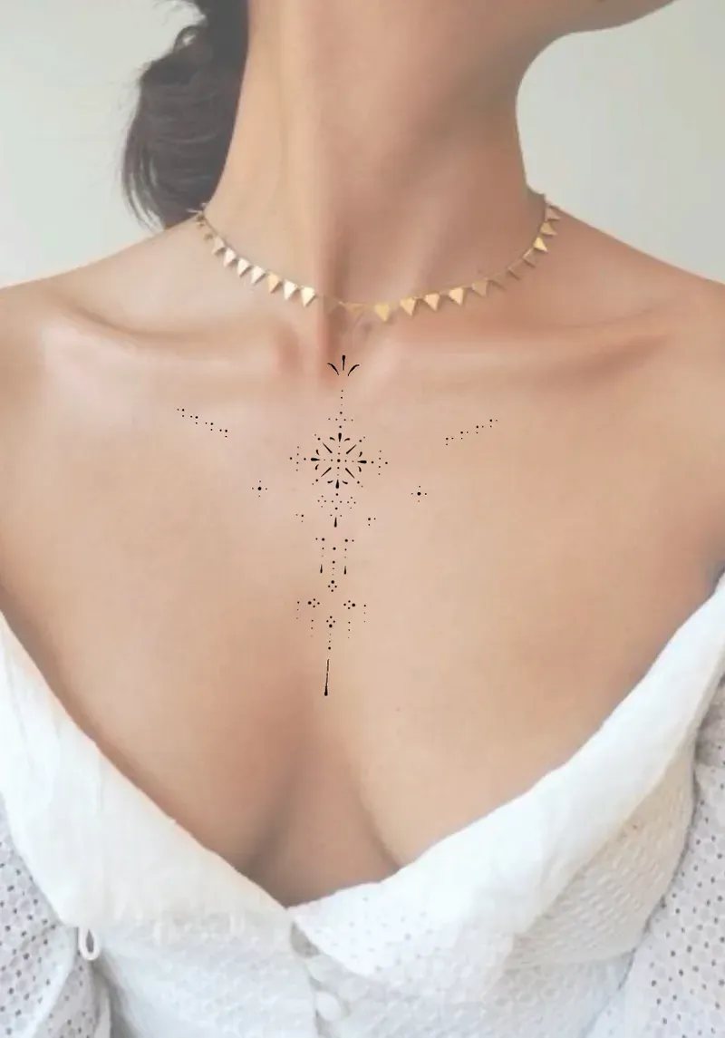 Minimalist dotwork geometric tattoo on chest.