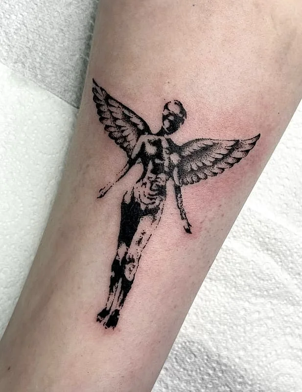 Blackwork angel with wings on forearm, healed work