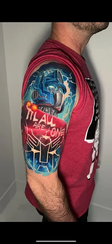 Vibrant Transformers tattoo on a man's arm.
