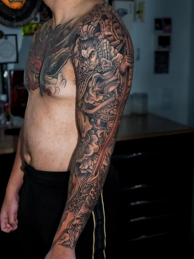 Detailed samurai warrior tattoo on a man's arm.