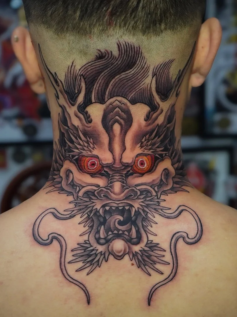 Large Japanese dragon tattoo on neck and back.