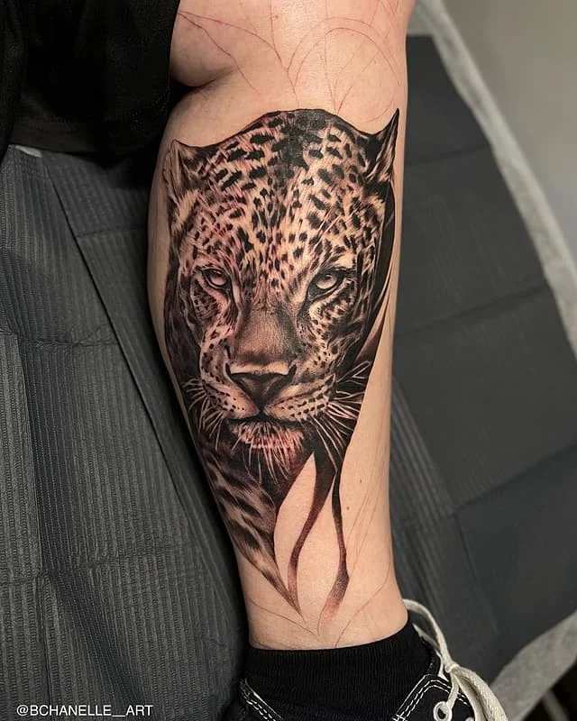 Realistic leopard tattoo on calf.