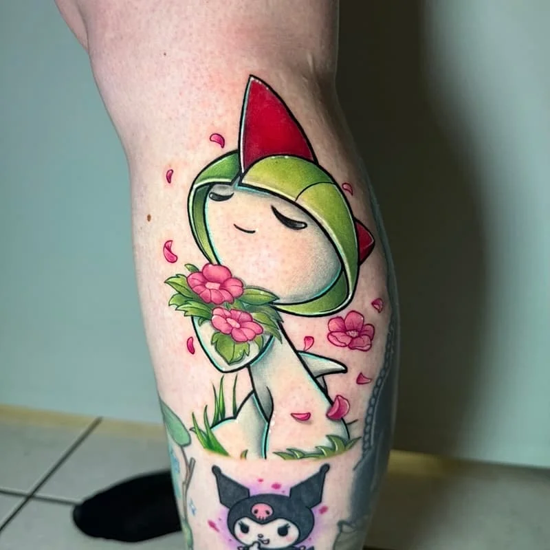 Colorful cartoon character tattoo on calf with flowers.