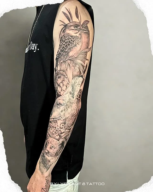 Large black-and-grey realistic wildlife tattoo on forearm.
