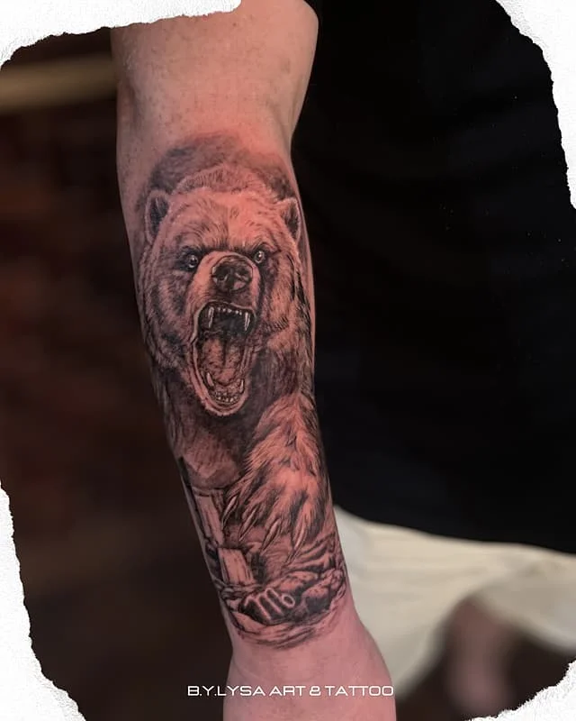 Realistic bear tattoo on forearm.