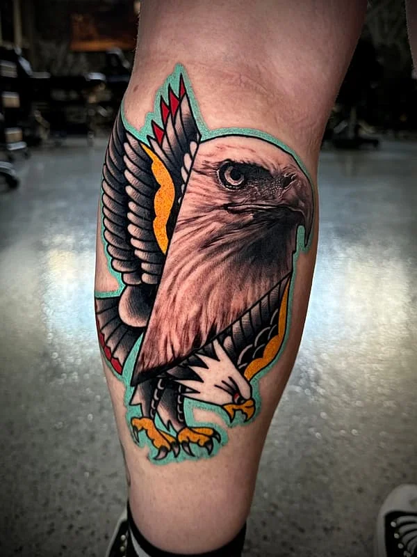 Colorful eagle tattoo on calf showcasing traditional style.