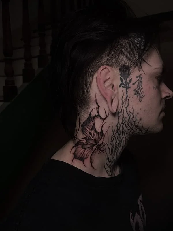 Intricate floral and abstract line art neck tattoo.