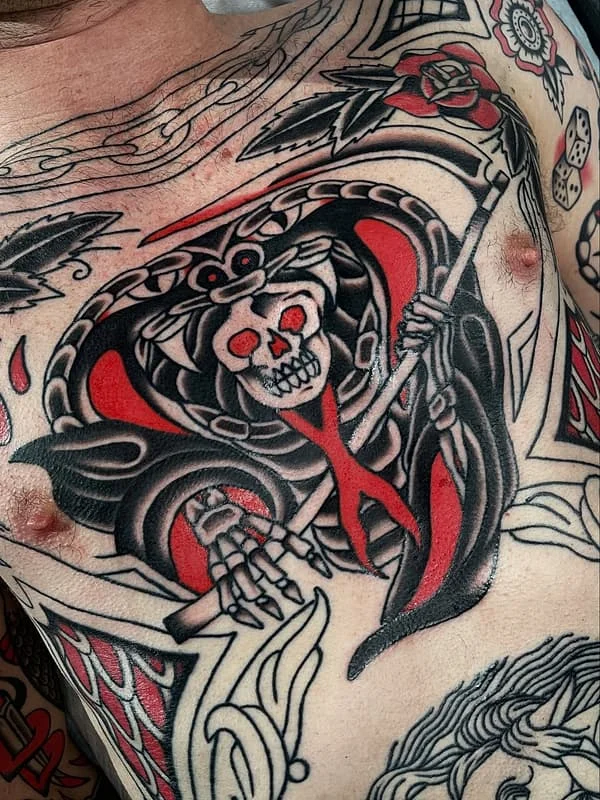 Traditional grim reaper tattoo on chest with skull and rose.