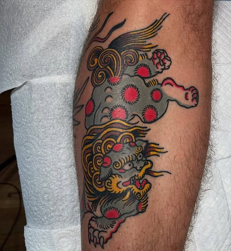 Colorful Japanese lion tattoo on arm.