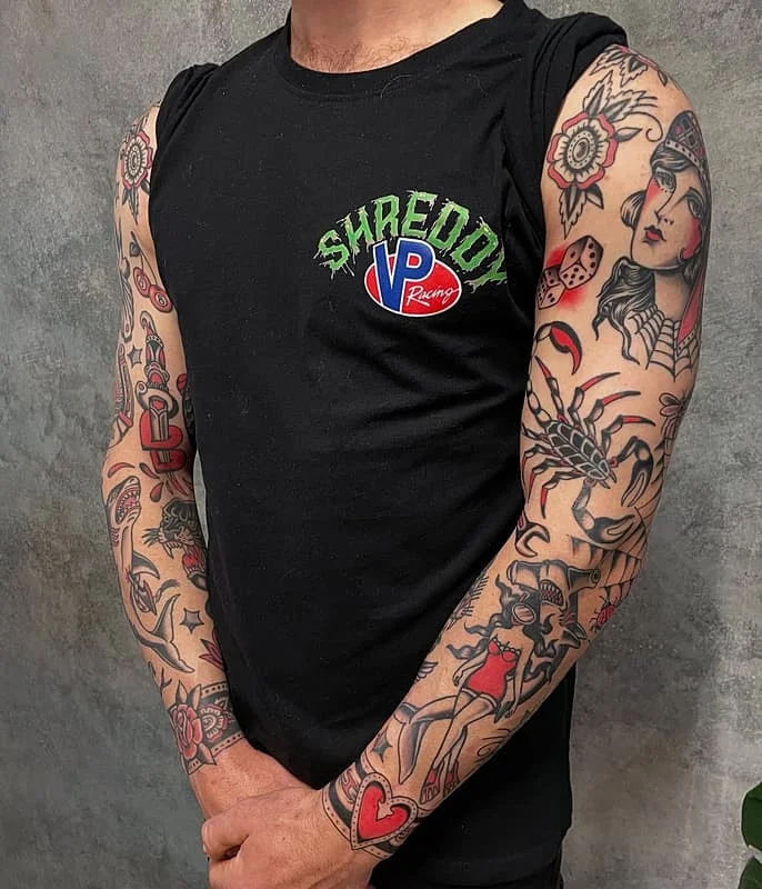 Colorful full-sleeve tattoo with vintage and floral designs.