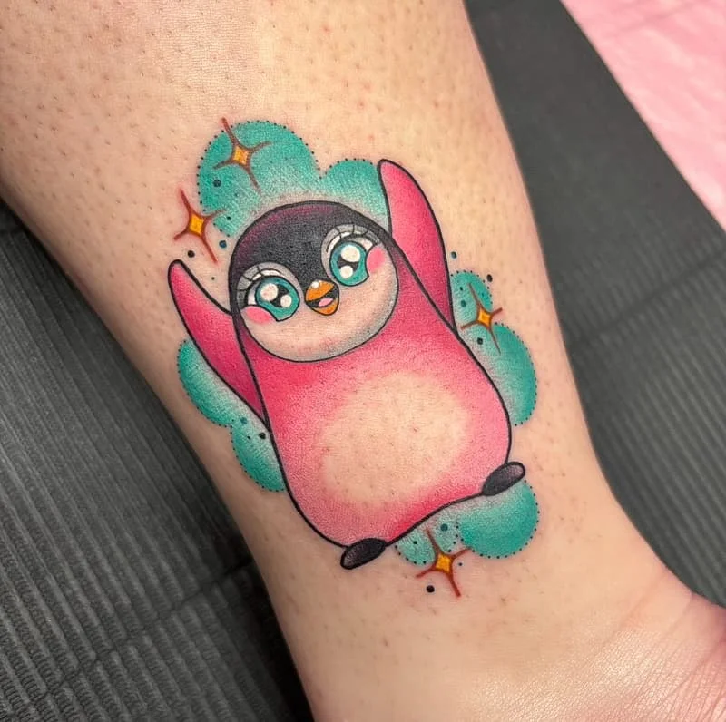 Colorful cartoon penguin tattoo on ankle.