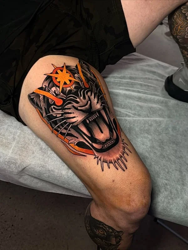 Colorful roaring tiger tattoo on thigh.