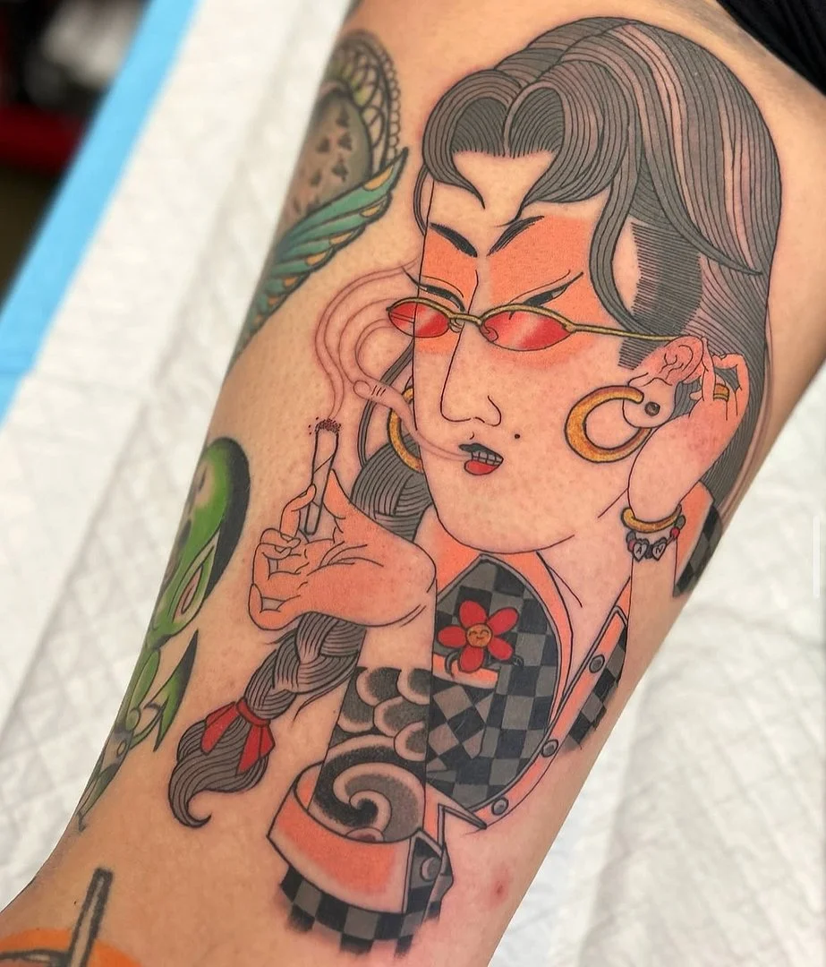 Japanese geisha tattoo on leg with vibrant colors.