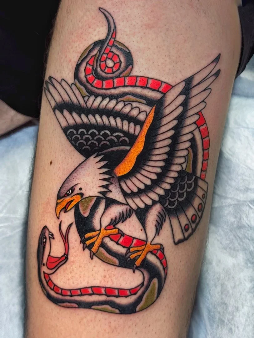 Traditional tattoo of an eagle and snake on leg.
