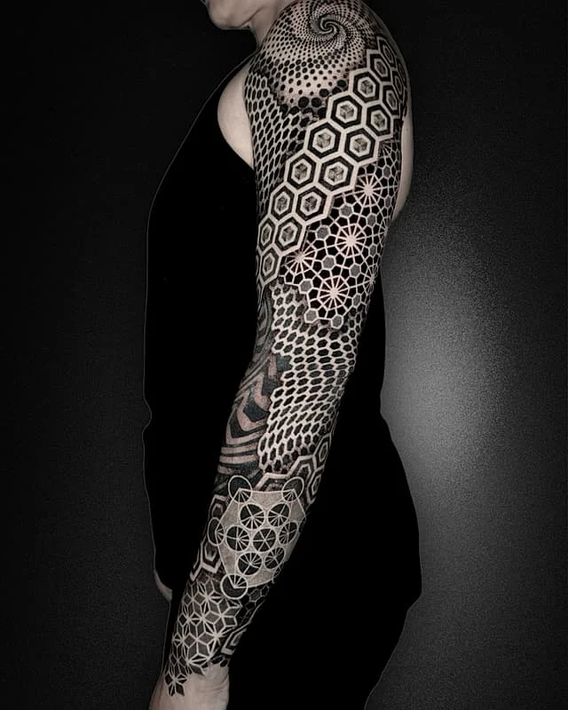 Intricate geometric full-sleeve tattoo on arm.