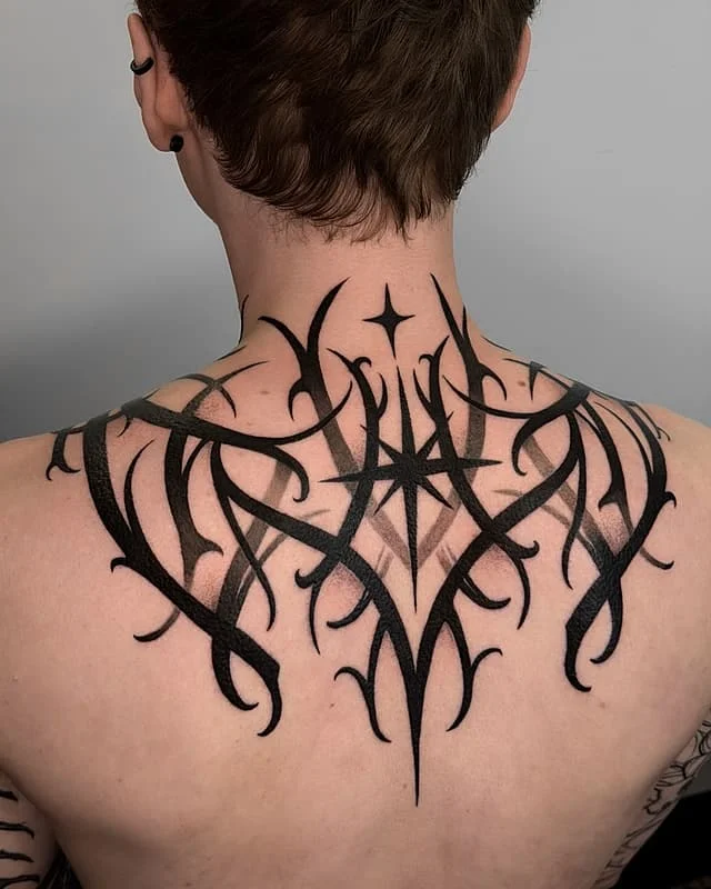 Large black tribal tattoo on the back.