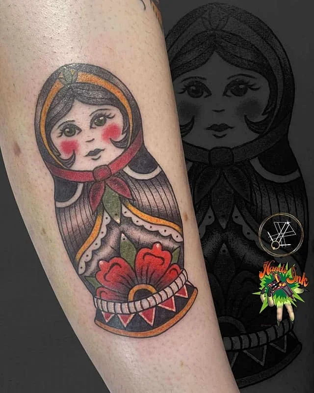 Traditional matryoshka doll tattoo on forearm.