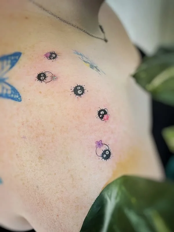 Colorful whimsical tattoo on shoulder and chest.