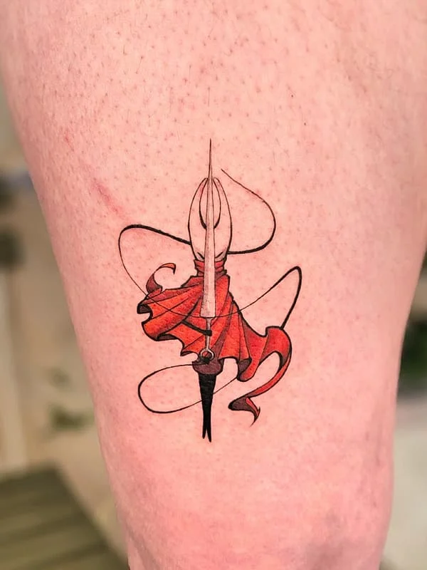 Colorful ink pen tattoo with red ribbon on thigh.