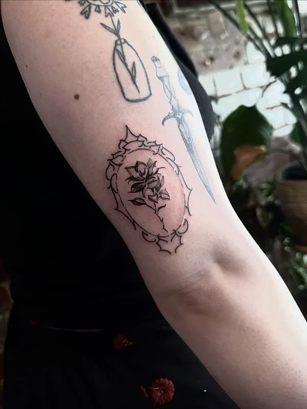 Medium blackwork floral tattoo on arm.