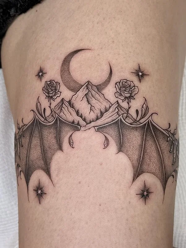 Black and grey bat tattoo with mountains and moon on thigh