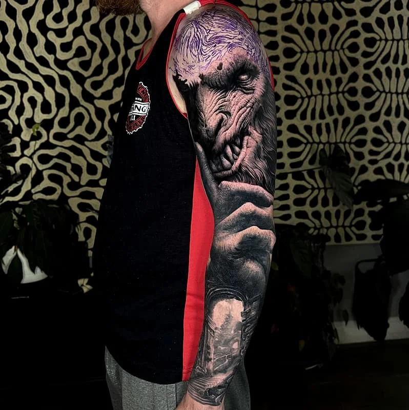 Detailed full-sleeve tattoo of an elephant on arm.