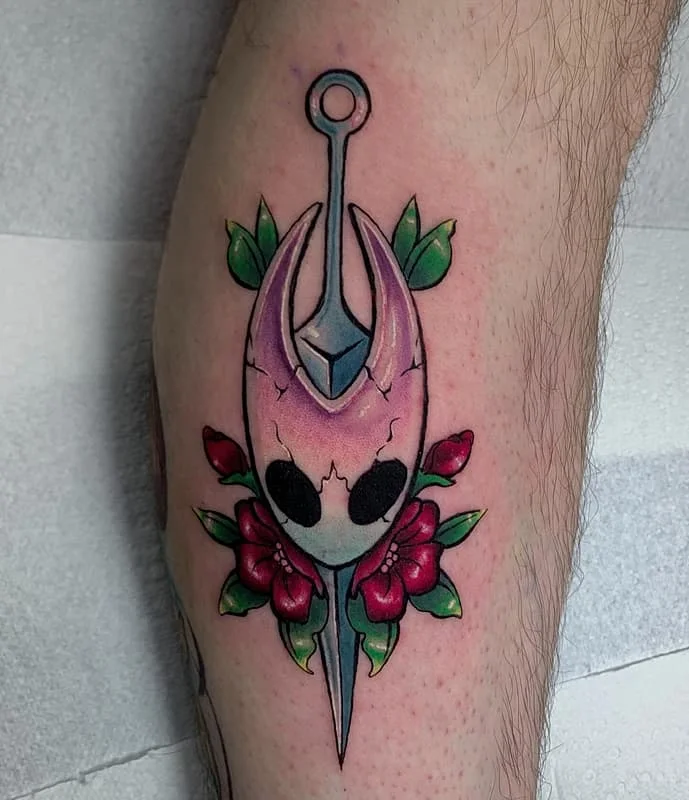 Colourful illustrative skull and floral tattoo on a leg