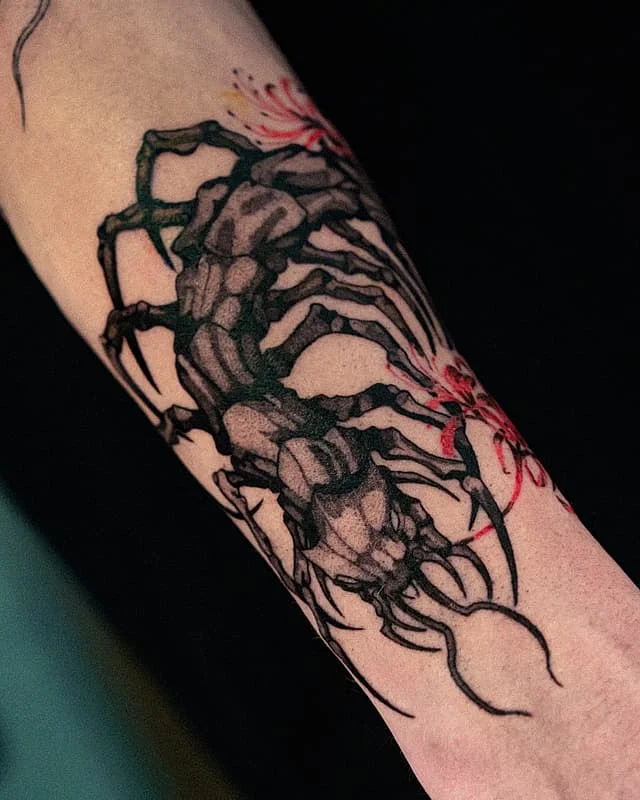 Illustrative scorpion tattoo on forearm.