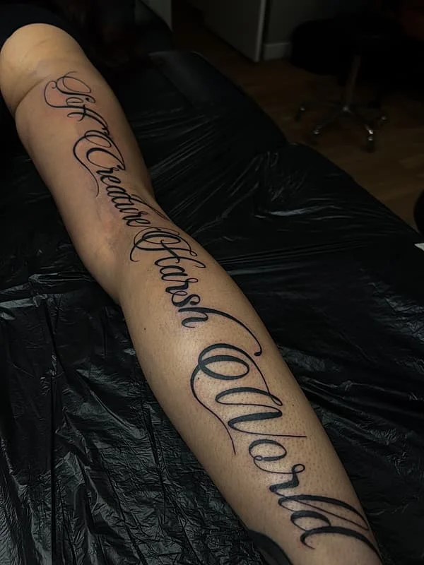 Elegant script tattoo on forearm with inspirational quote.