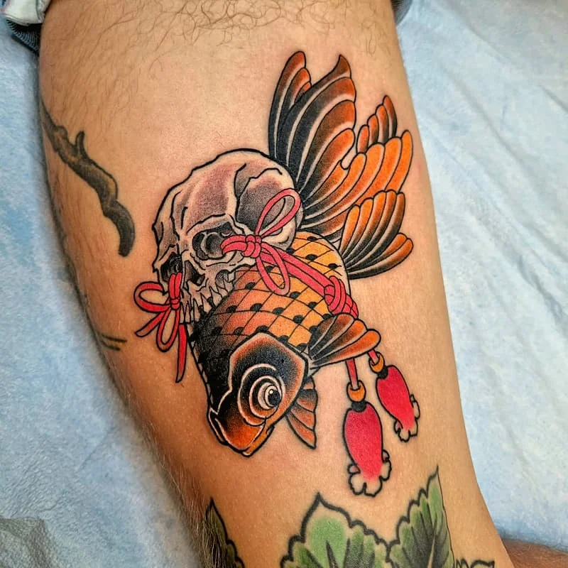 Colorful koi fish and skull tattoo on leg.