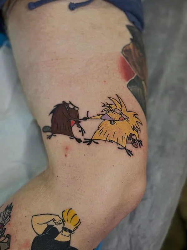 Colorful cartoon tattoo of animals on arm.