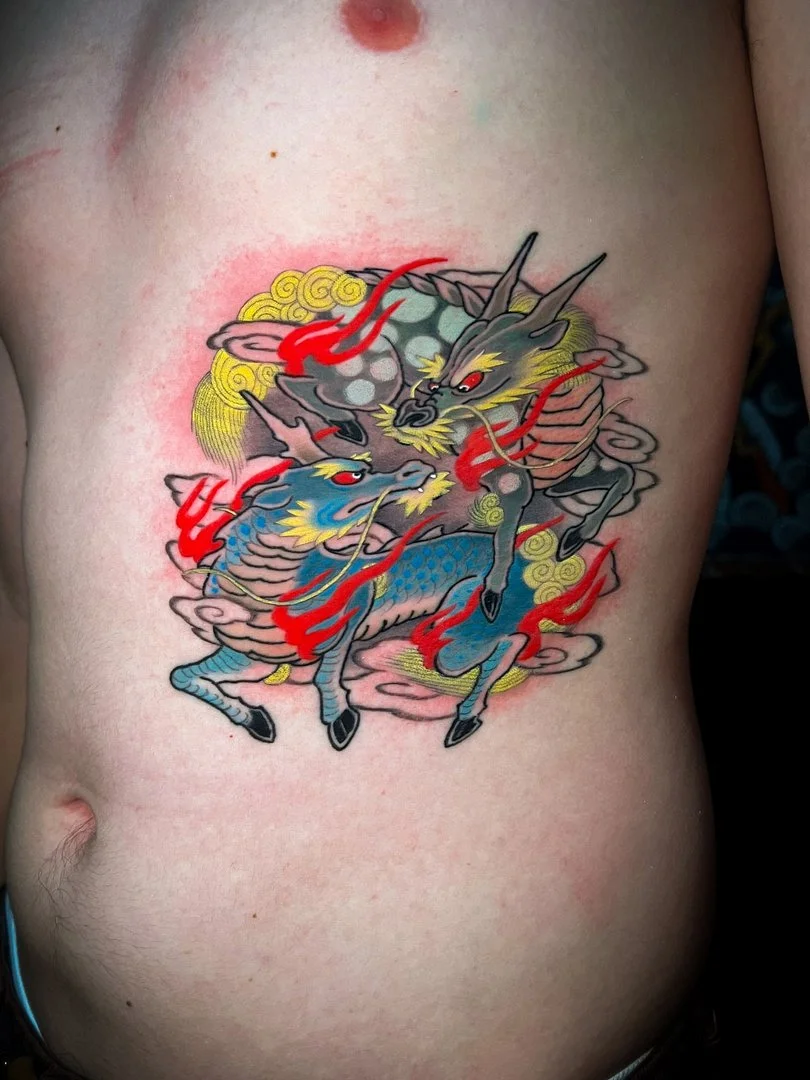 Colorful Japanese tattoo of a mythical creature on chest.
