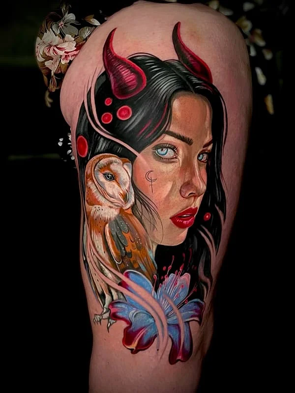 Large colorful tattoo of a woman with horns and an owl.