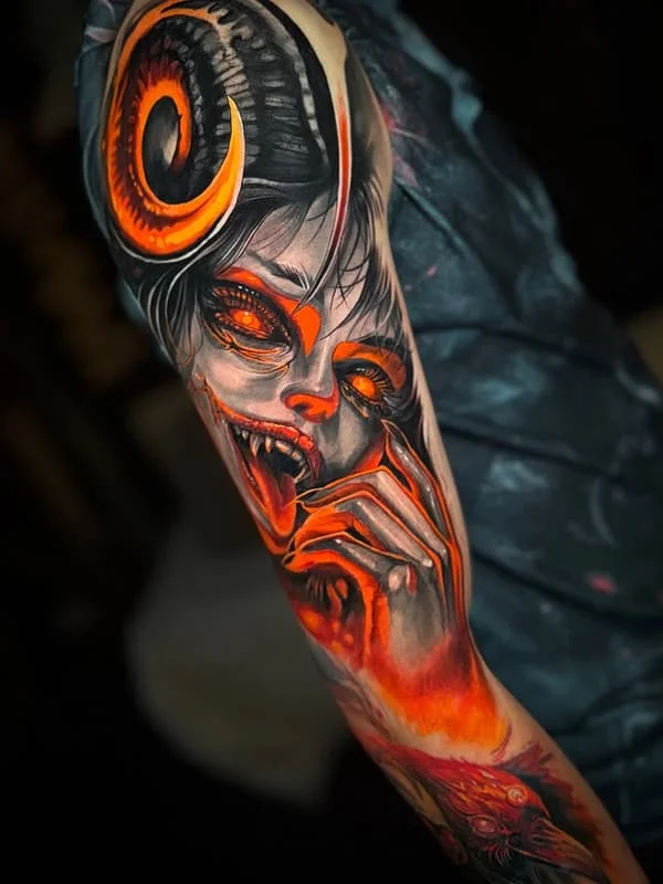 Large colorful demon tattoo on arm.