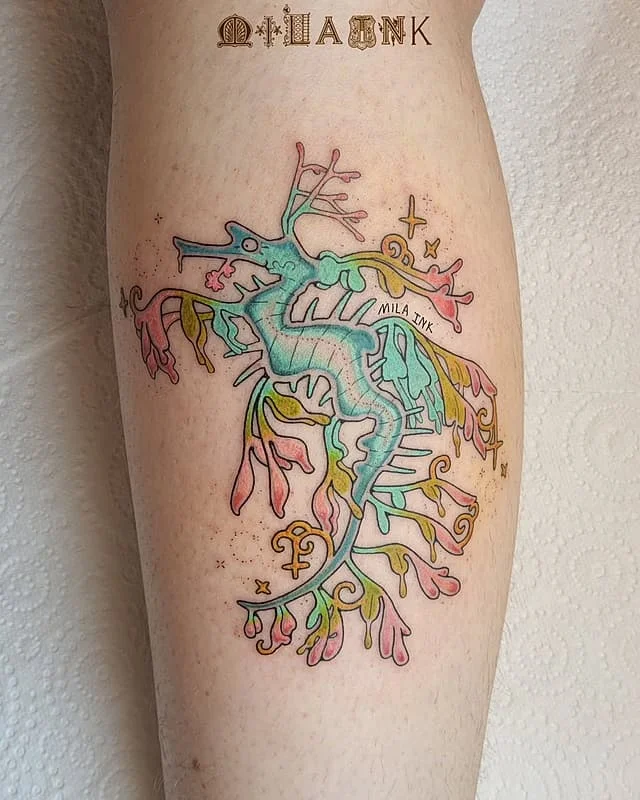 Colorful watercolor seahorse tattoo on leg.