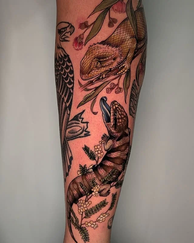 Colorful lizard and flora tattoo on forearm.