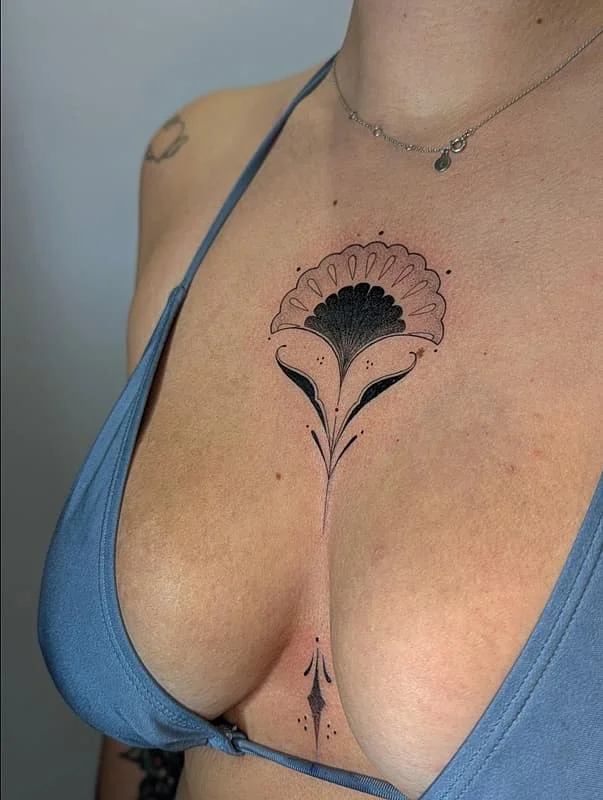 Elegant fine line floral tattoo on a chest