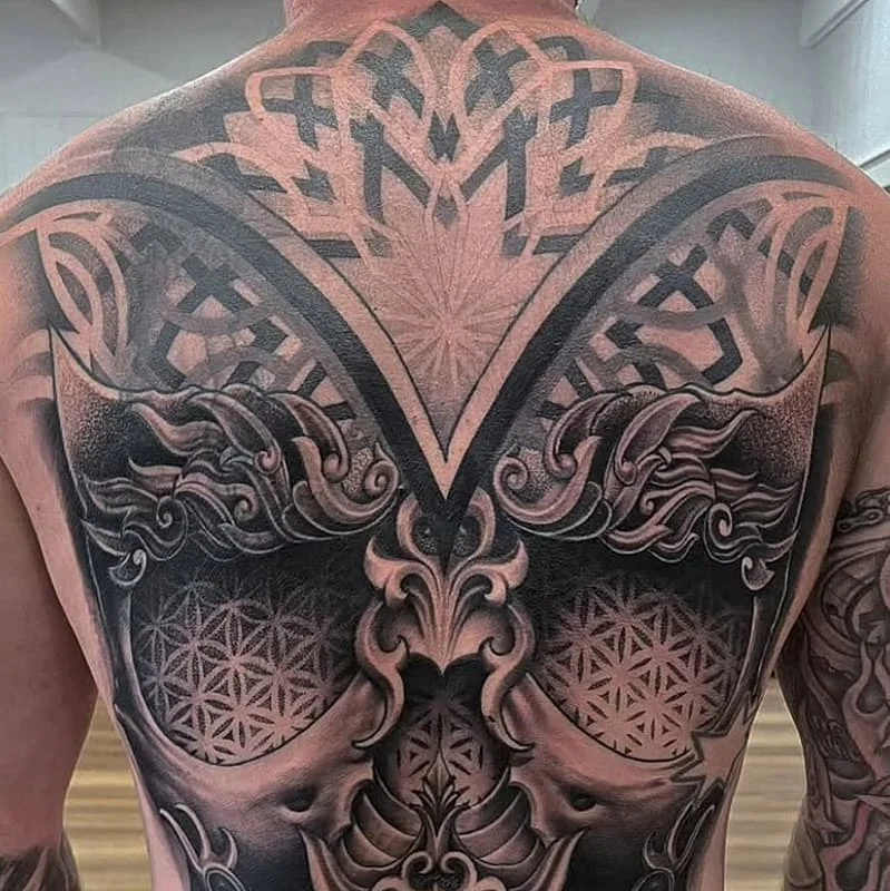 Large black-and-grey tattoo covering the entire back.