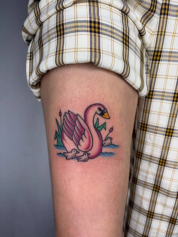 Colorful traditional tattoo of a swan on an arm.