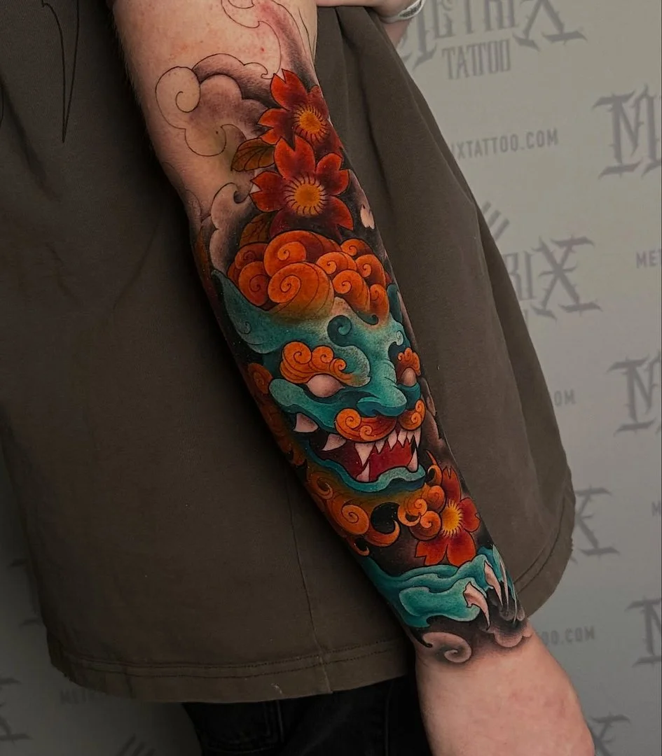 Vibrant Japanese dragon tattoo on forearm.