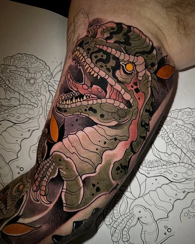 Colorful T-Rex tattoo on an arm.
