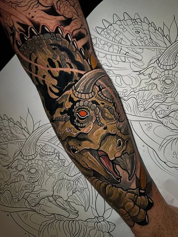 Detailed dragon tattoo on forearm with illustrative style.