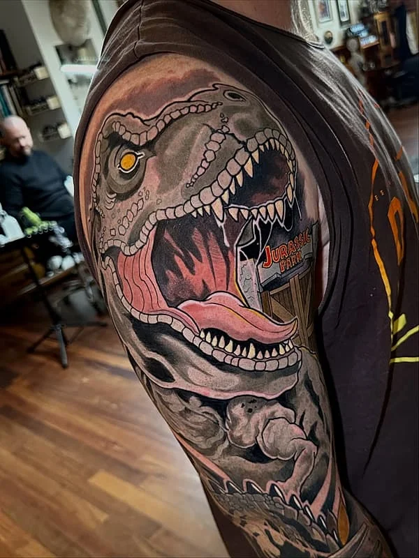 Colorful dinosaur tattoo on a full sleeve.