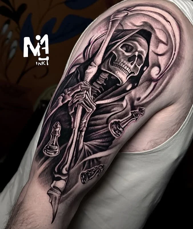 Black-and-grey grim reaper tattoo on arm.