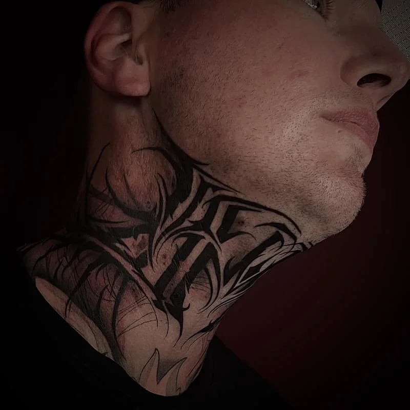 Intricate blackwork tattoo on the neck.