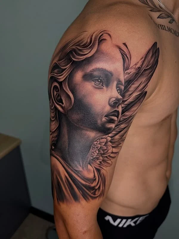 Detailed black and grey angel portrait tattoo showing the level of realism achievable for memorial portrait work