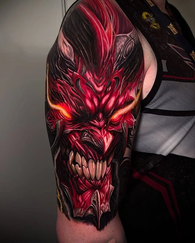 Large 3D demon tattoo on male arm.