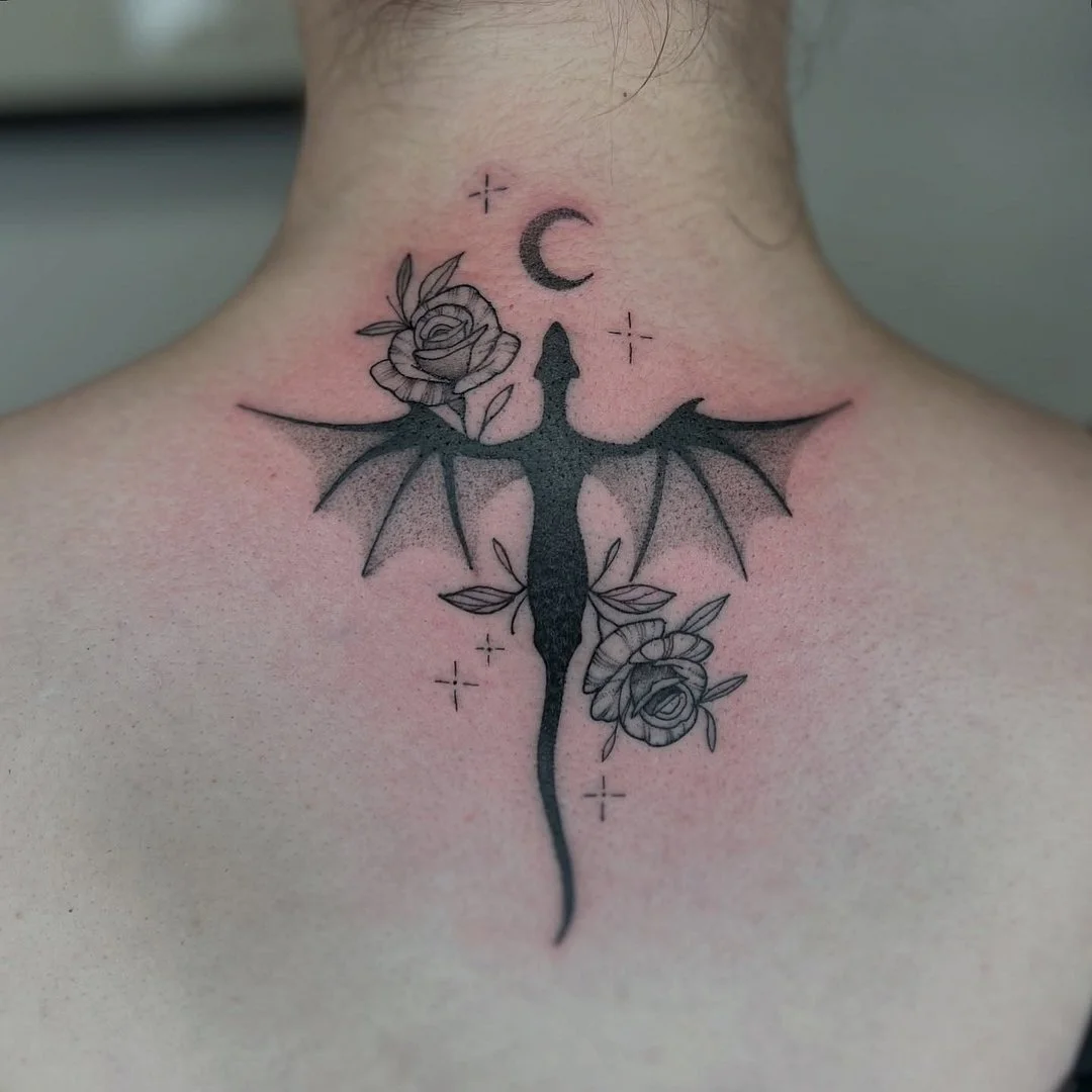 Blackwork dragon with roses and moon showing dense fill useful for absorbing old tattoos