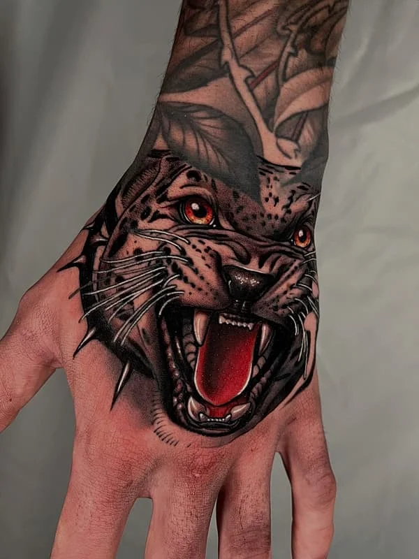 Illustrative panther tattoo on a hand.