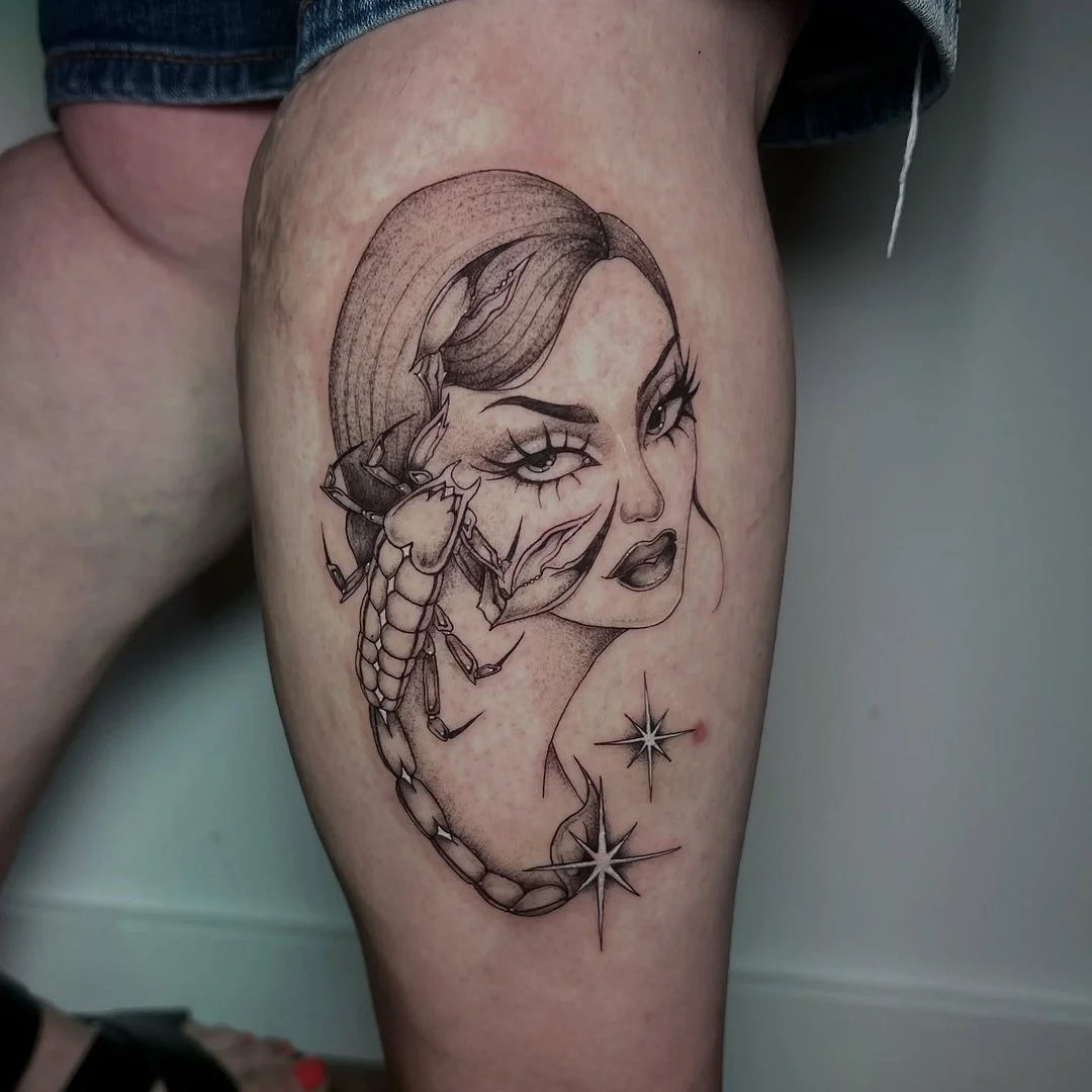 Black-and-grey tattoo of a woman's face and scorpion.